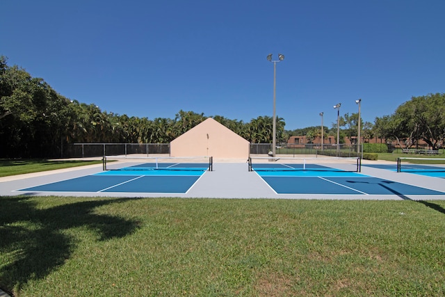 exterior space with a yard and tennis court