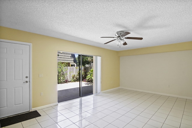 tiled empty room featuring a textured ceiling and ceiling fan