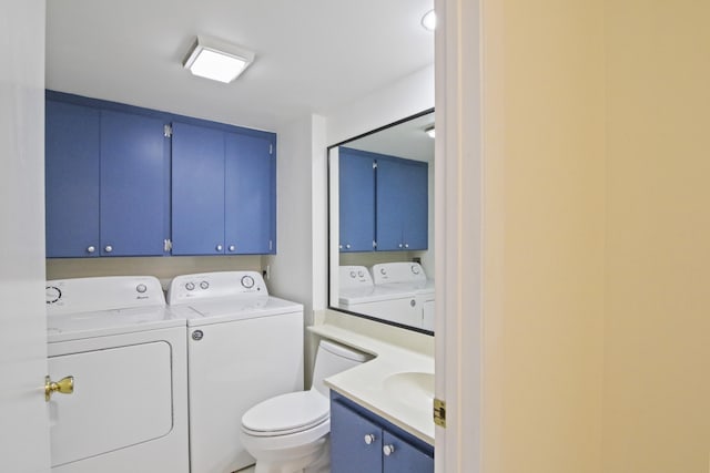 bathroom featuring vanity, separate washer and dryer, and toilet