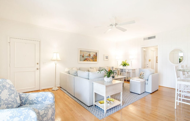 living room featuring ceiling fan and light wood-type flooring