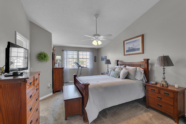 carpeted bedroom with lofted ceiling, ceiling fan, and a textured ceiling