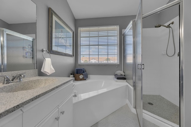 bathroom with vanity and shower with separate bathtub