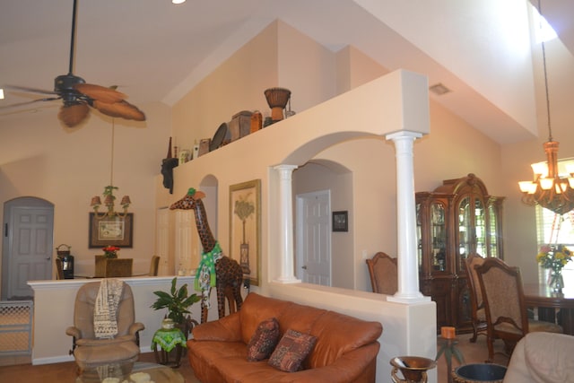 living room featuring high vaulted ceiling, decorative columns, and ceiling fan with notable chandelier