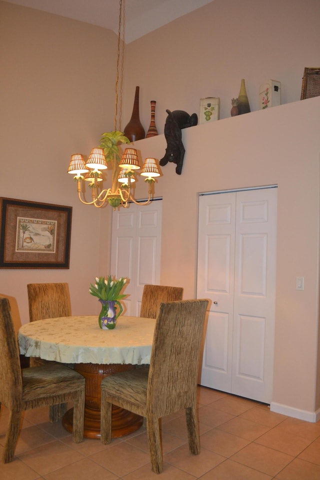 tiled dining room with a chandelier