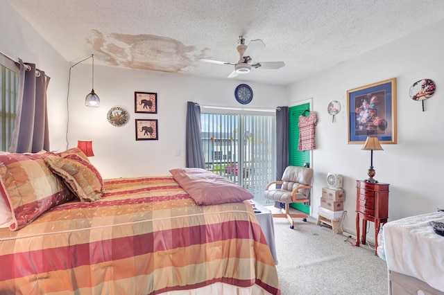 bedroom featuring light carpet, a textured ceiling, ceiling fan, and access to outside