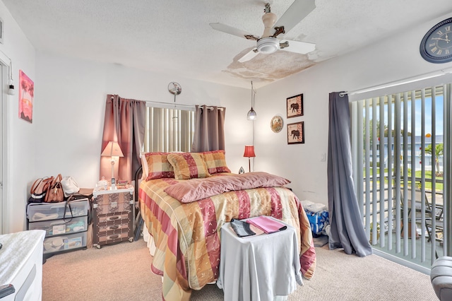 carpeted bedroom with a textured ceiling and ceiling fan