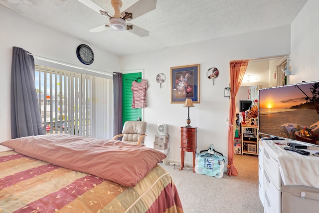 carpeted bedroom featuring a textured ceiling and ceiling fan