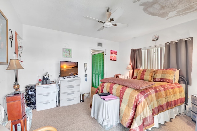 bedroom with ceiling fan and light colored carpet