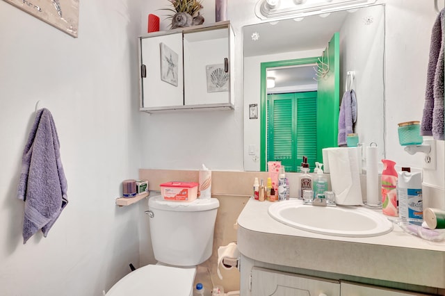 bathroom with toilet and large vanity