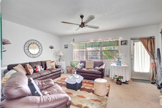 carpeted living room featuring a textured ceiling and ceiling fan