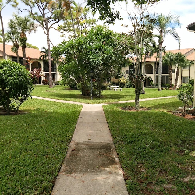 view of home's community with a yard