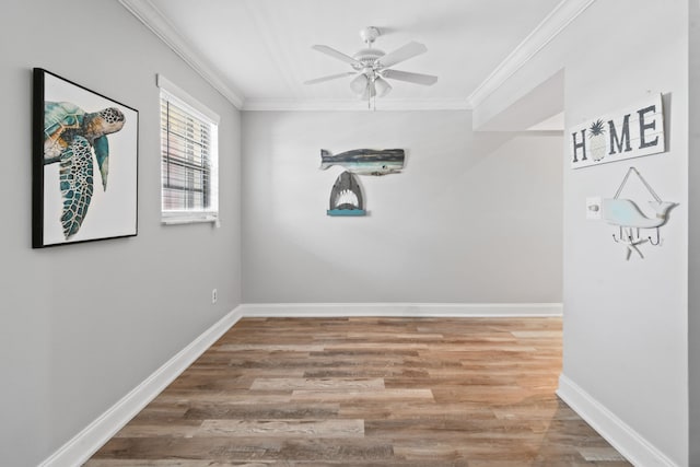 empty room featuring ceiling fan, ornamental molding, and light hardwood / wood-style flooring