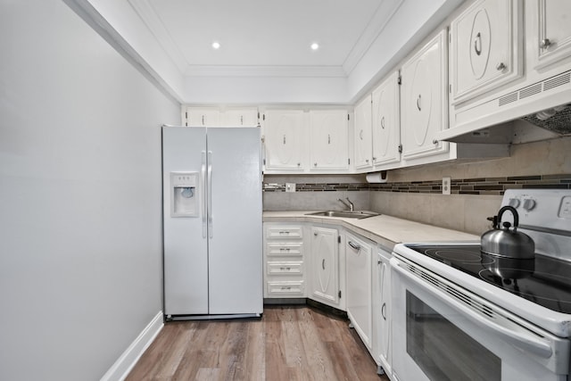 kitchen with white cabinetry, white appliances, sink, crown molding, and hardwood / wood-style flooring