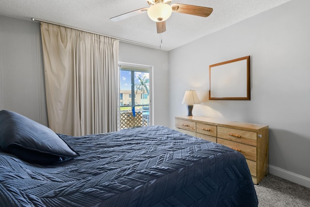 carpeted bedroom featuring a textured ceiling and ceiling fan