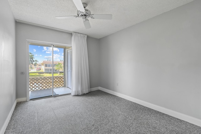 carpeted empty room with ceiling fan and a textured ceiling