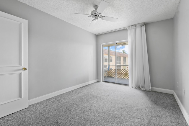 carpeted empty room with a textured ceiling and ceiling fan