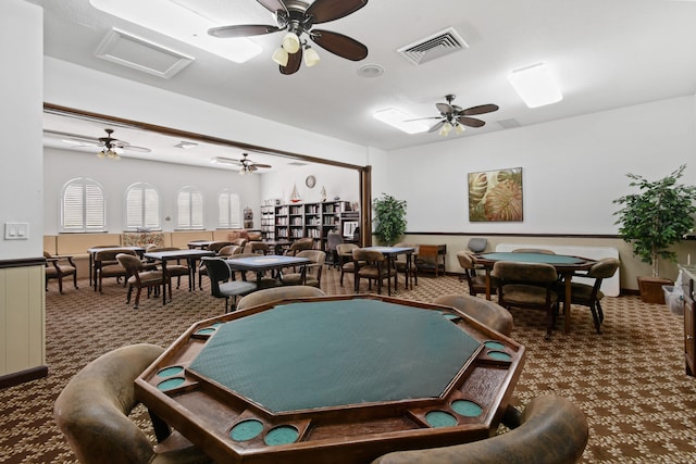 playroom with dark colored carpet and ceiling fan