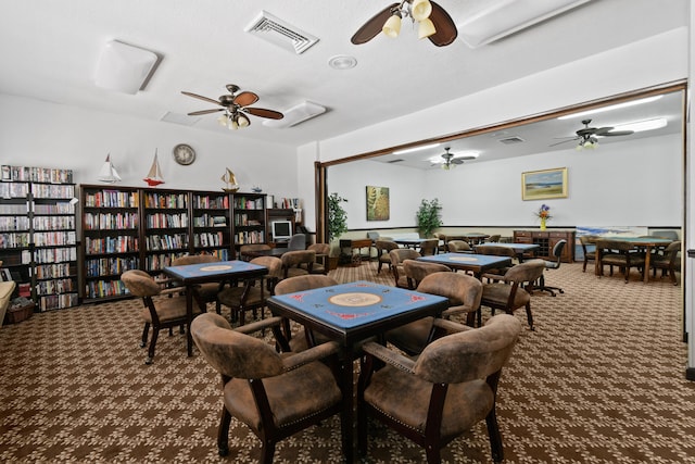 carpeted dining room featuring ceiling fan