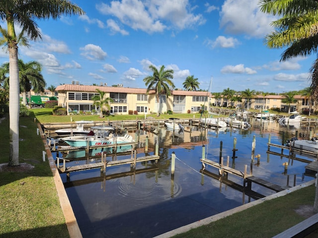 dock area featuring a water view and a yard