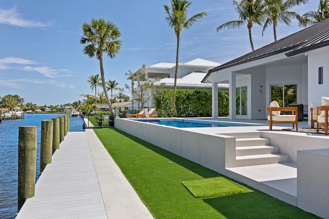 exterior space with a water view, a fenced in pool, and a patio area