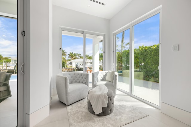 sitting room featuring a healthy amount of sunlight and light tile flooring