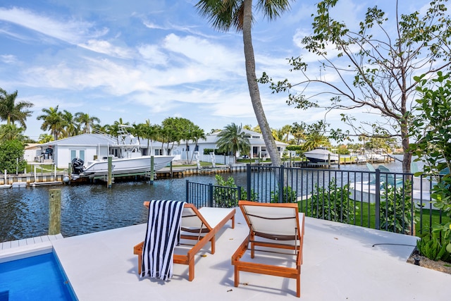 view of patio with a dock and a water view