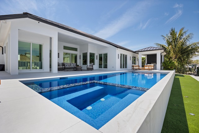 view of swimming pool featuring a patio area and an outdoor living space with a fireplace