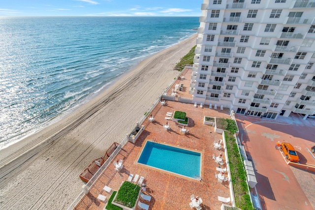 birds eye view of property with a beach view and a water view