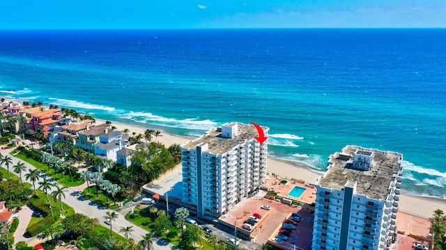 birds eye view of property featuring a view of the beach and a water view