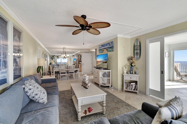 tiled living room with a textured ceiling, ceiling fan with notable chandelier, and crown molding