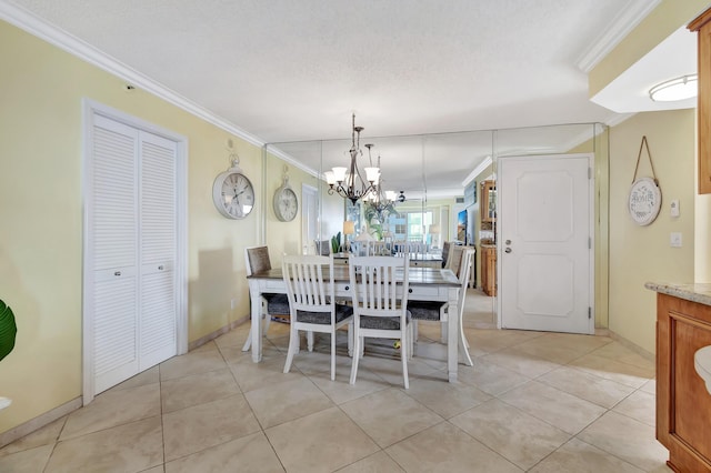 dining space featuring ornamental molding, a textured ceiling, a notable chandelier, and light tile patterned flooring