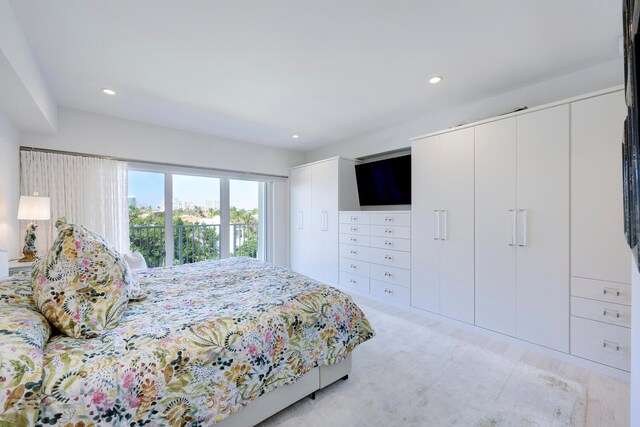 bedroom with two closets and light colored carpet