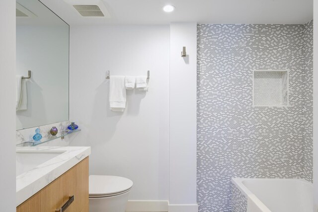 bathroom featuring toilet, tile floors, and vanity