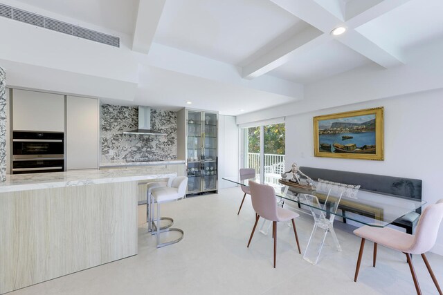 dining area featuring beam ceiling and coffered ceiling