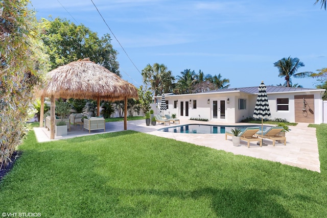 back of property featuring a lawn, an outdoor living space, french doors, a gazebo, and a patio area