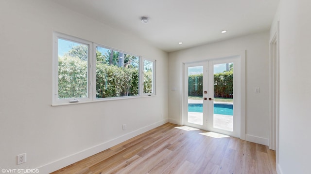 empty room featuring light hardwood / wood-style floors and french doors