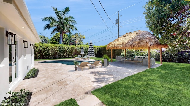 view of swimming pool featuring a lawn, a patio area, and an outdoor hangout area