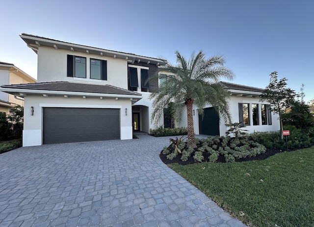 view of front of home with a front lawn and a garage