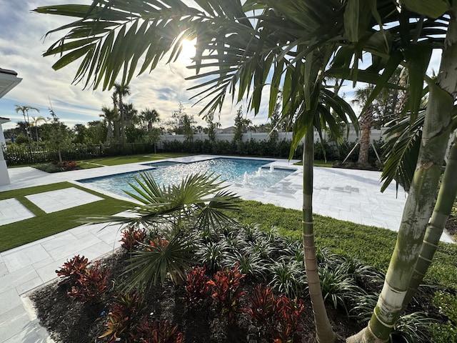 view of swimming pool featuring pool water feature and a patio