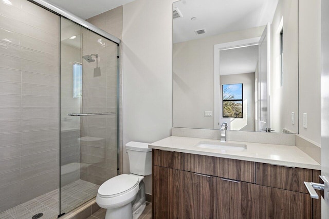 bathroom featuring vanity, toilet, and an enclosed shower