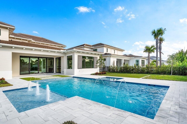 view of pool with a yard, a patio area, and pool water feature