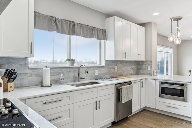 kitchen featuring a healthy amount of sunlight, sink, and stainless steel appliances