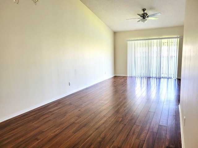 empty room featuring dark hardwood / wood-style floors, ceiling fan, and a textured ceiling