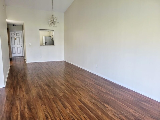 interior space with a notable chandelier and dark wood-type flooring