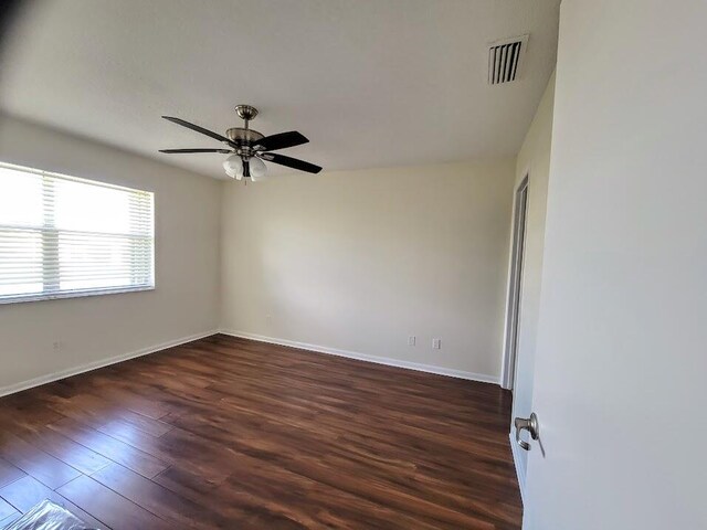 unfurnished room featuring dark hardwood / wood-style flooring and ceiling fan