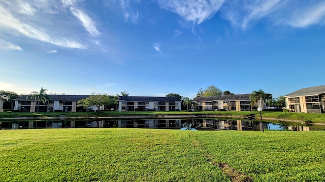 view of home's community featuring a yard and a water view