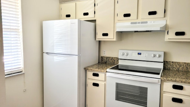 kitchen with white appliances and custom exhaust hood