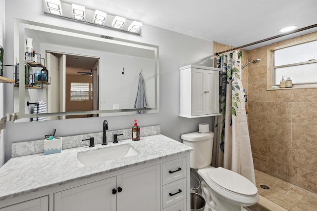 bathroom with toilet, vanity, and a shower with curtain