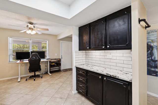 tiled office featuring ceiling fan