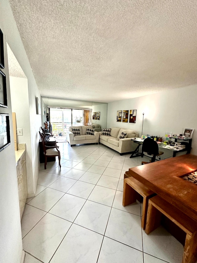 tiled living room with a textured ceiling